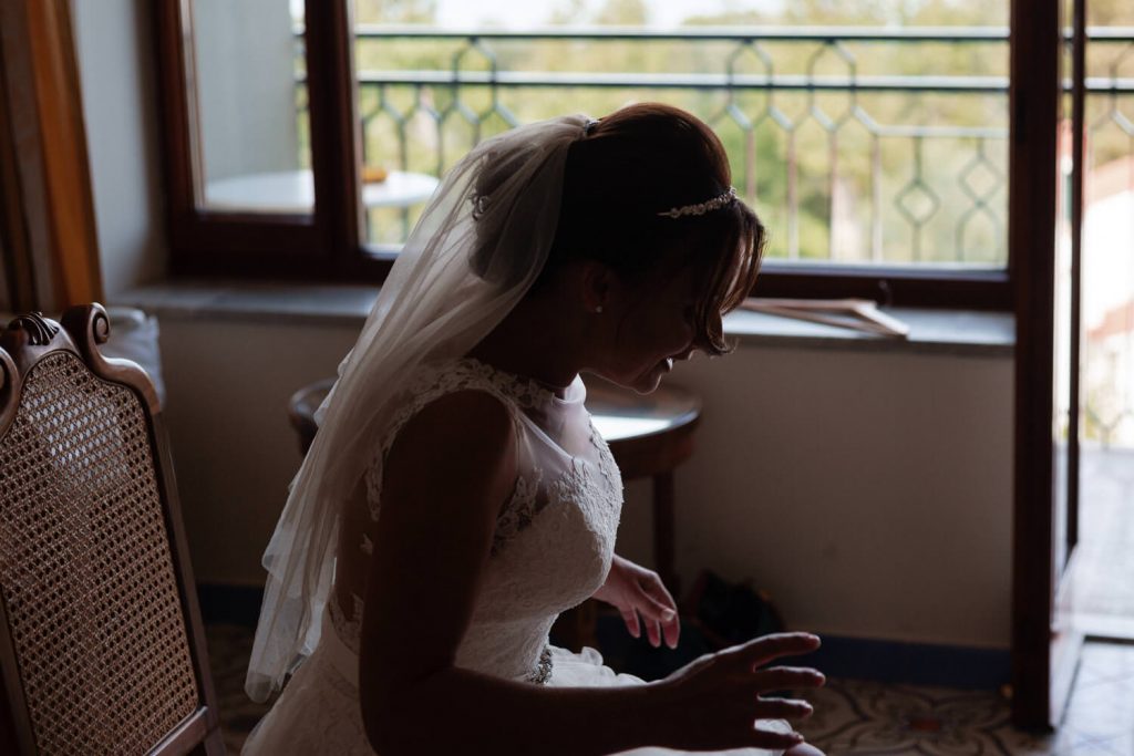 bride leaning over in shadow