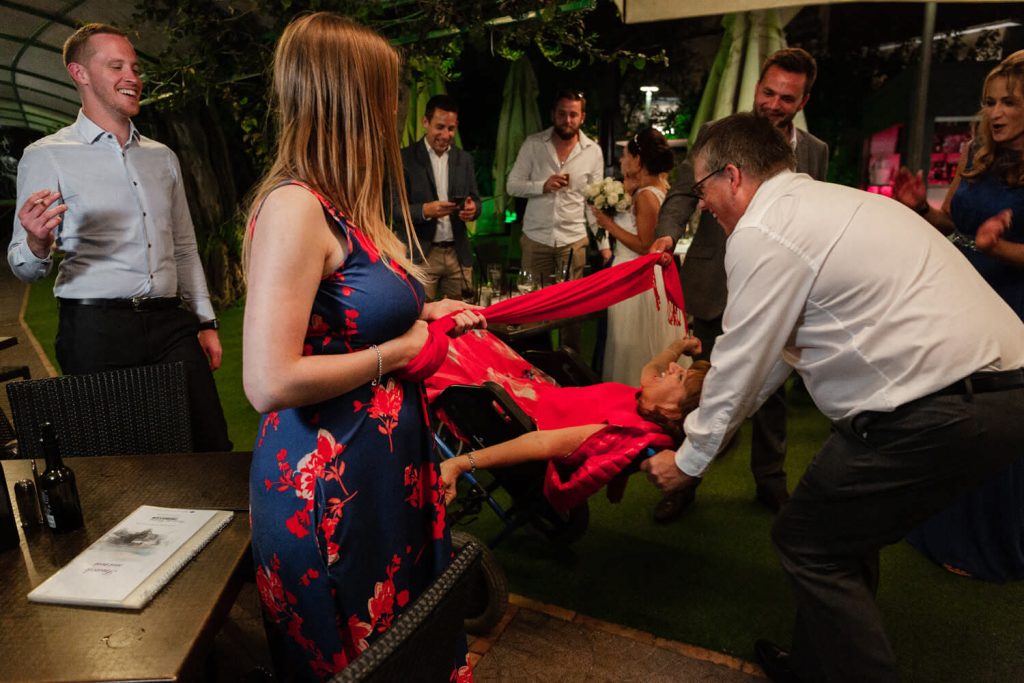 brides mother doing limbo in wheelchair