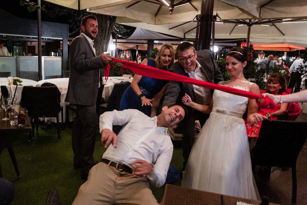 groom doing the limbo at wedding