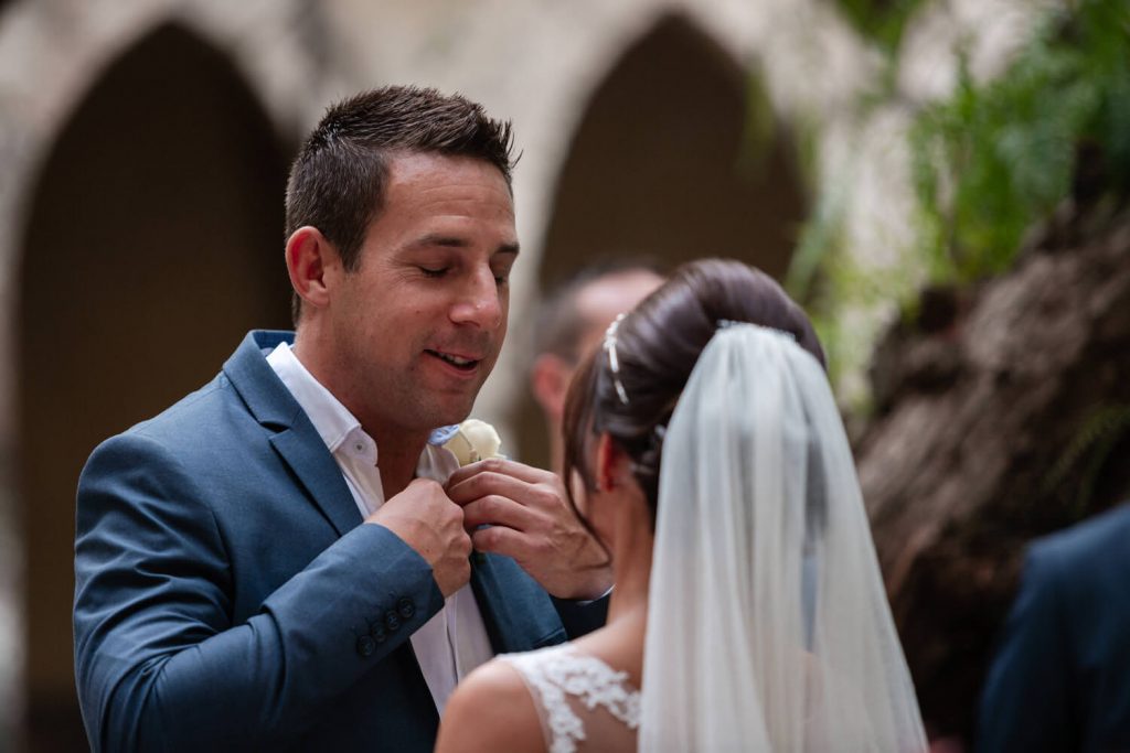 groom loosens tie at wedding