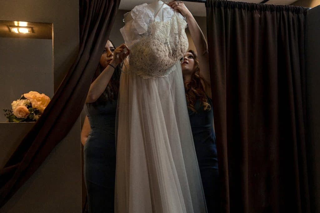 bridesmaids prepare the dress