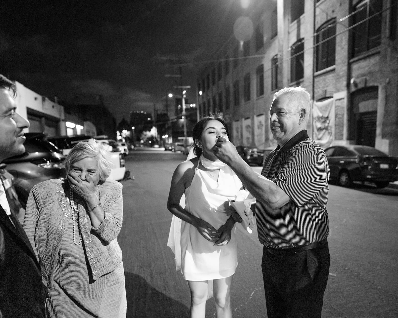 grandfather feeds bride a churro