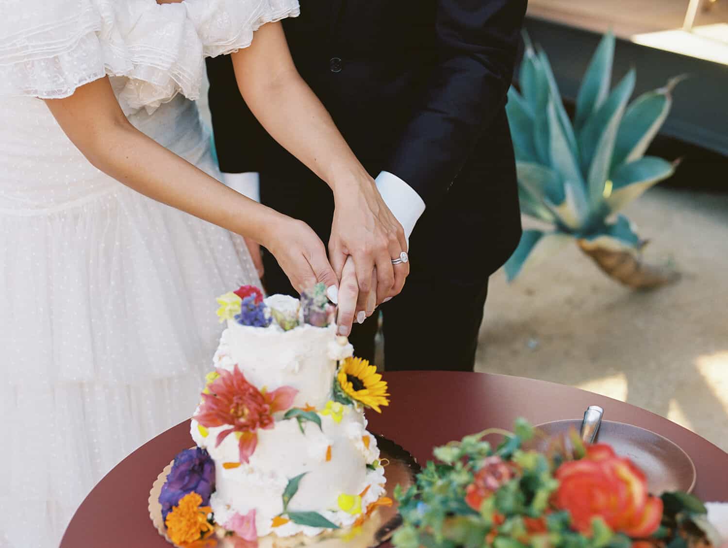 couple cut wedding cake on 35mm film