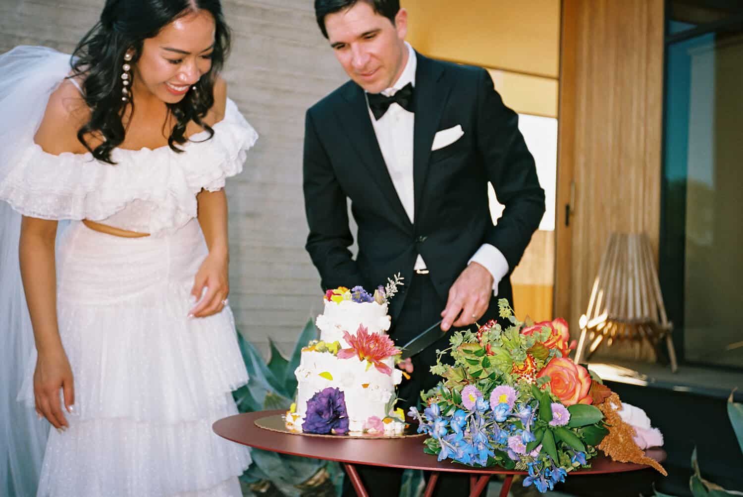 couple cut wedding cake on 35mm film