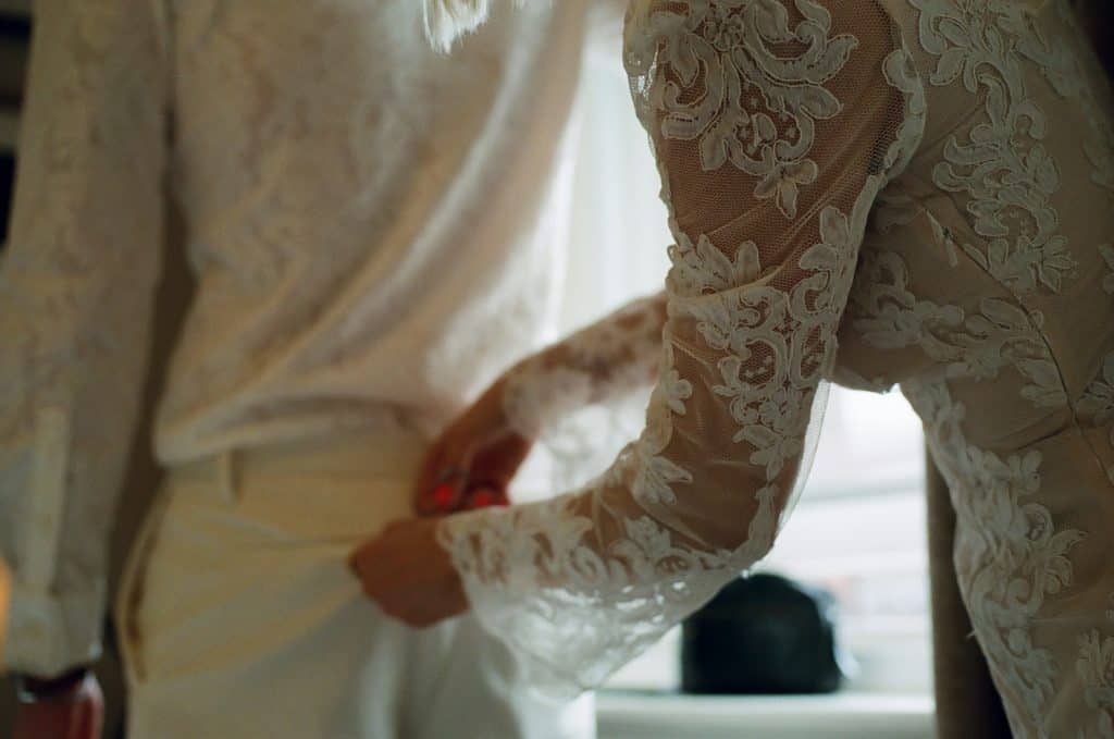 bride helps groom get ready