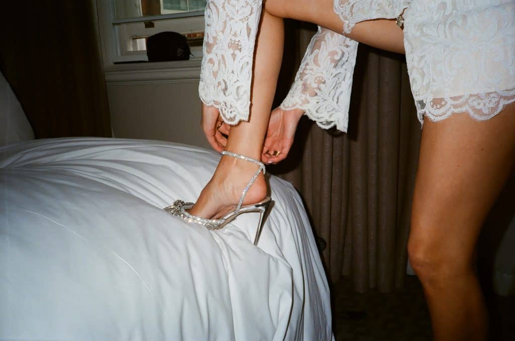 bride puts on shoes 35mm