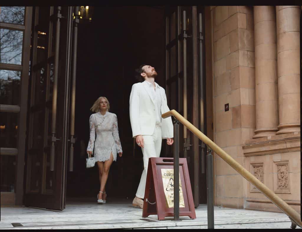 bride and groom leave the hotel