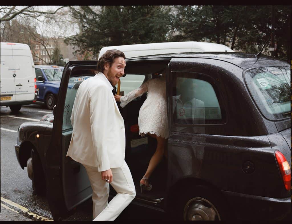 bride and groom get in a black cab in London