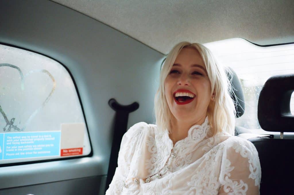 bride laughing in a black cab in london on 35mm film