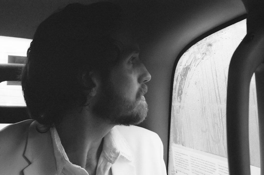 groom looks out of black cab window in london