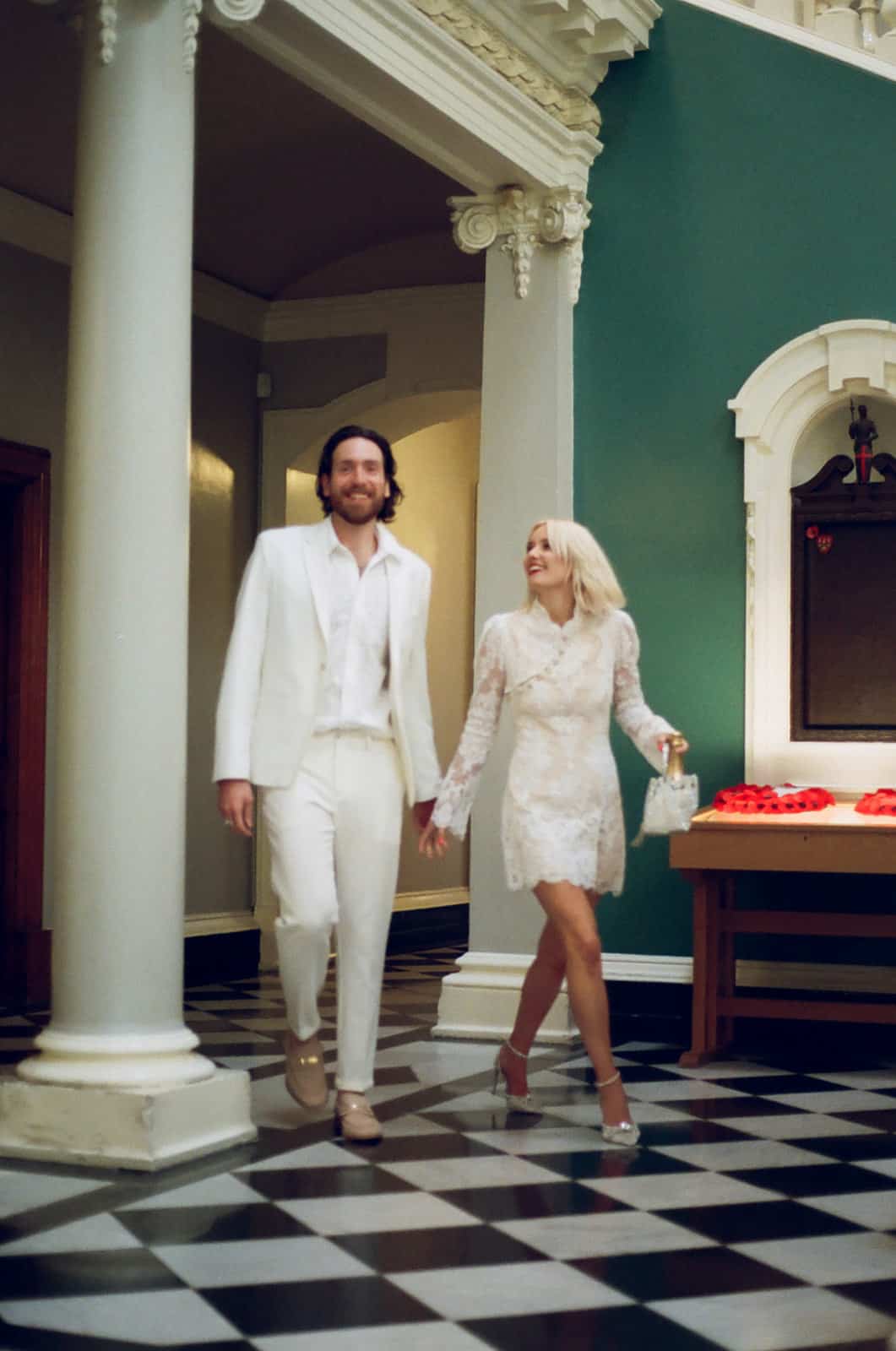 wedding couple walk through woolwich town hall holding hands