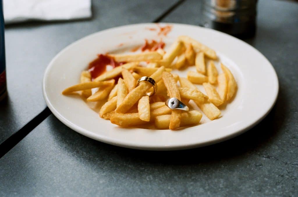 wedding rings on a plate of chips at wimpy on 35mm film