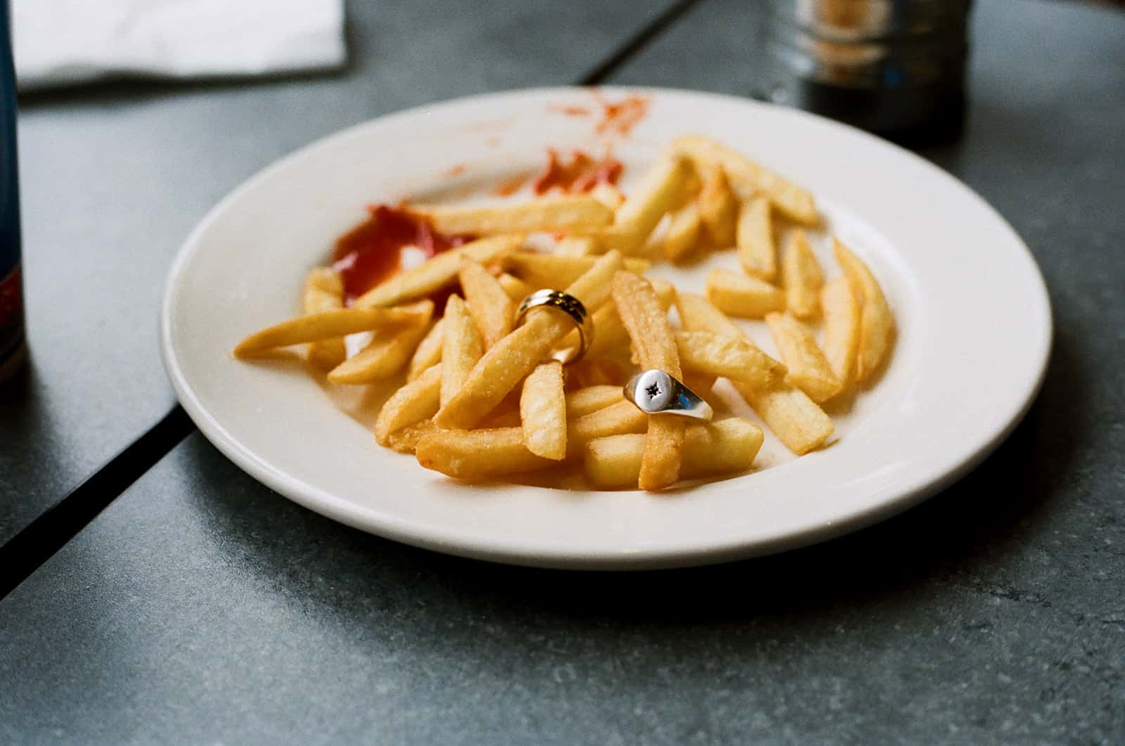 wedding rings on a plate of chips at wimpy london on 35mm film