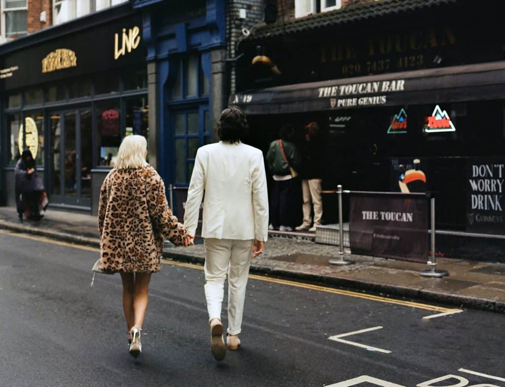 newlyweds walk into the toucan pub in soho london