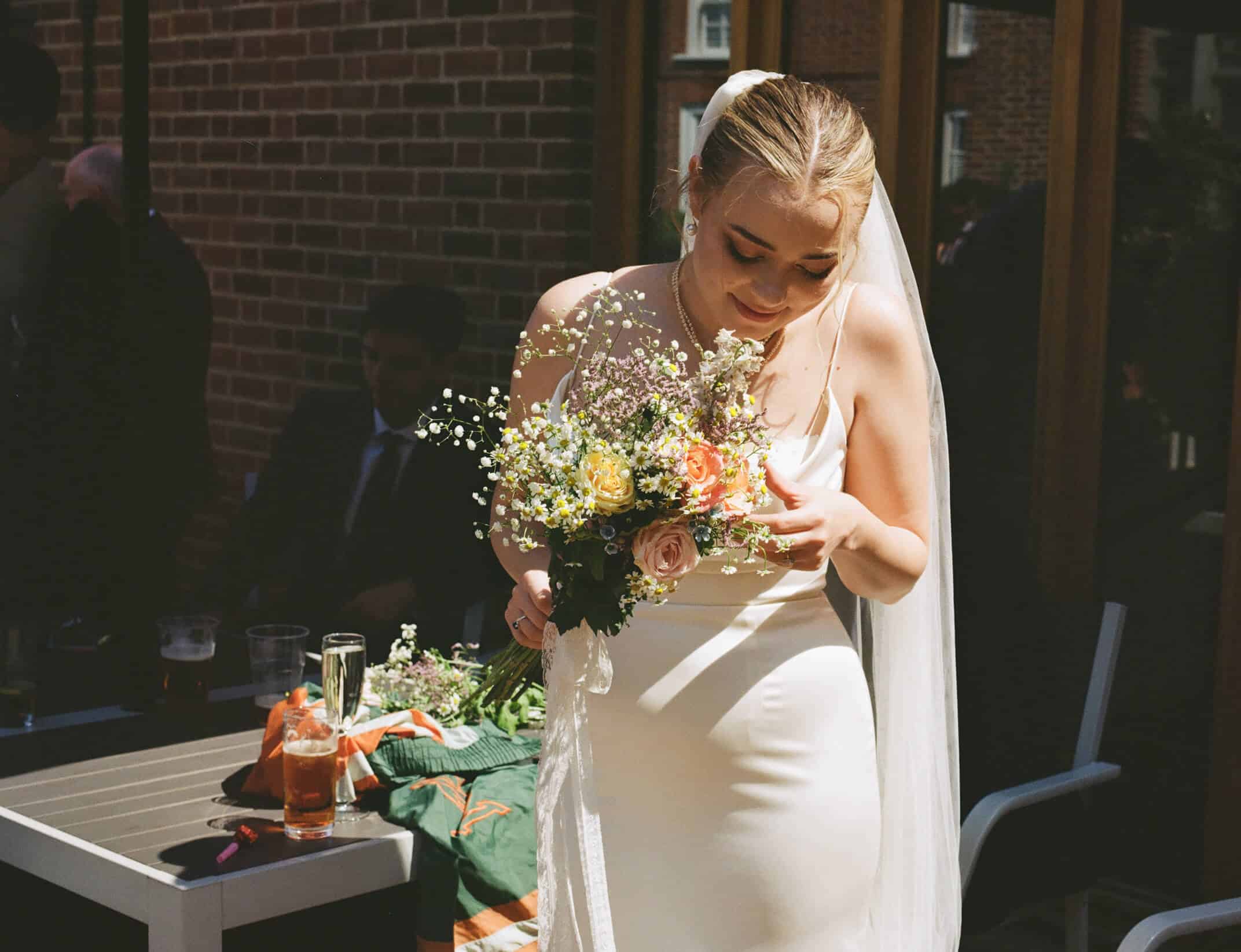 bride inspects her flowers
