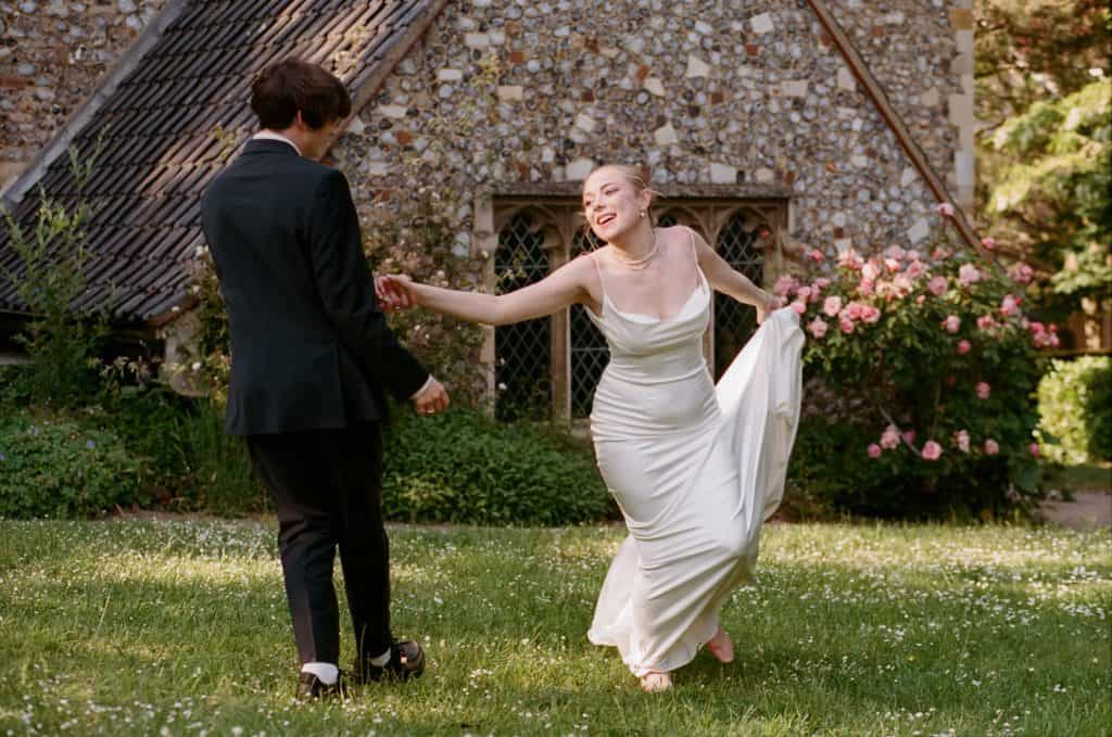 newlyweds dancing in churchyard
