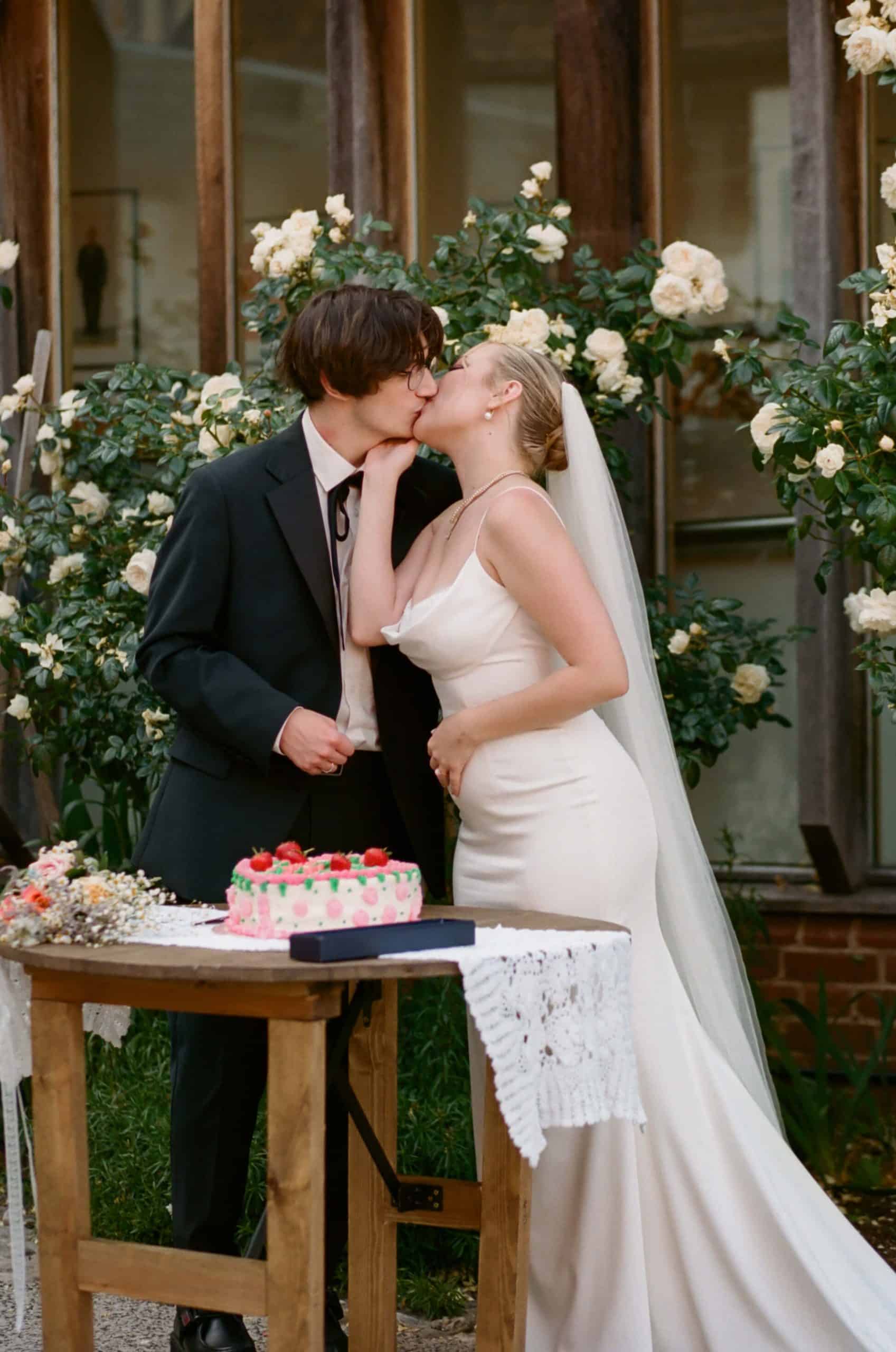 bride and groom enjoying wedding cake on film