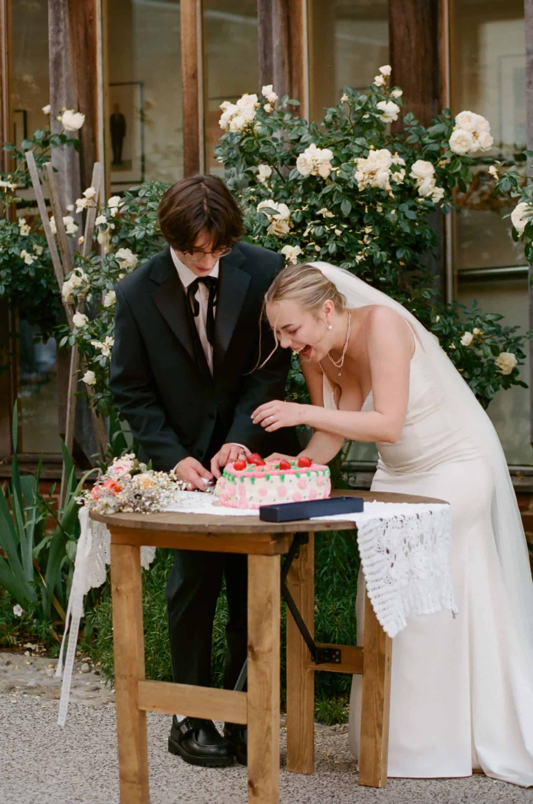 bride and groom cut cake