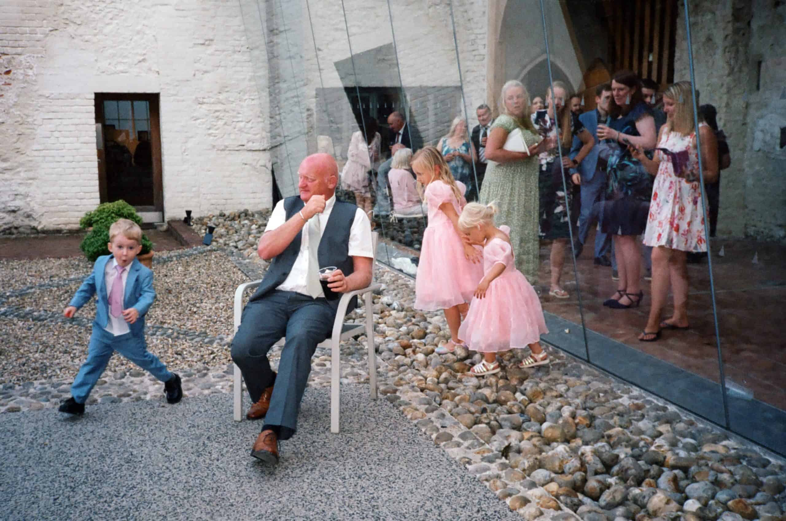 grandchildren running round grandad